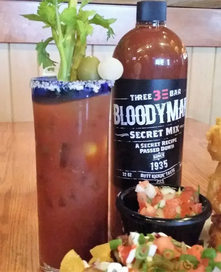 Bloody Mary poured over ice and garnished at the bar